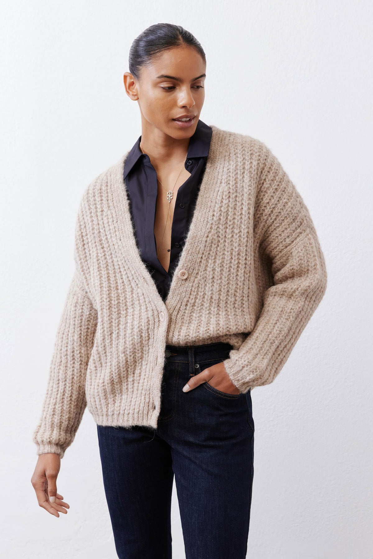 Oatmeal knit cardigan showing button placket and chunky knit texture