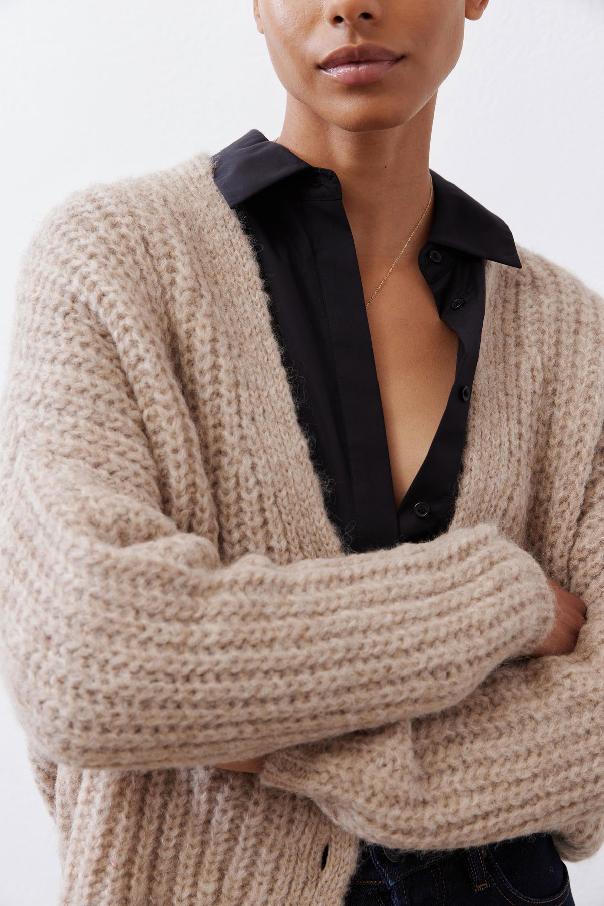 Oatmeal knit cardigan close-up of button placket and fuzzy yarn texture