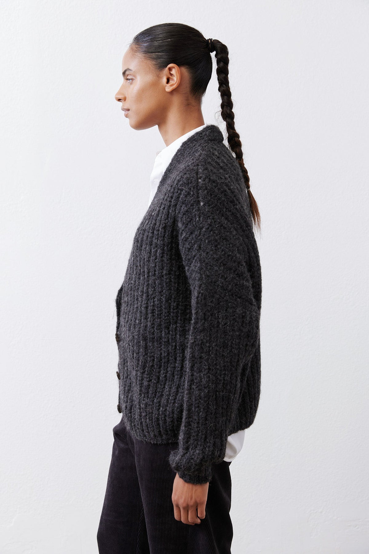 Charcoal heather knit cardigan in profile, button front and ribbed cuffs