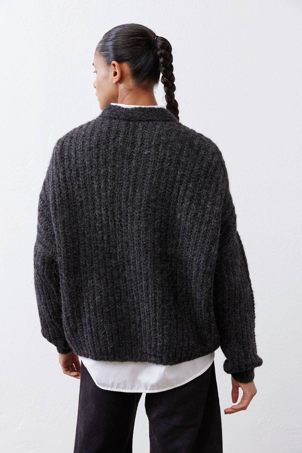 Back view of charcoal heather knit cardigan with ribbed cuffs