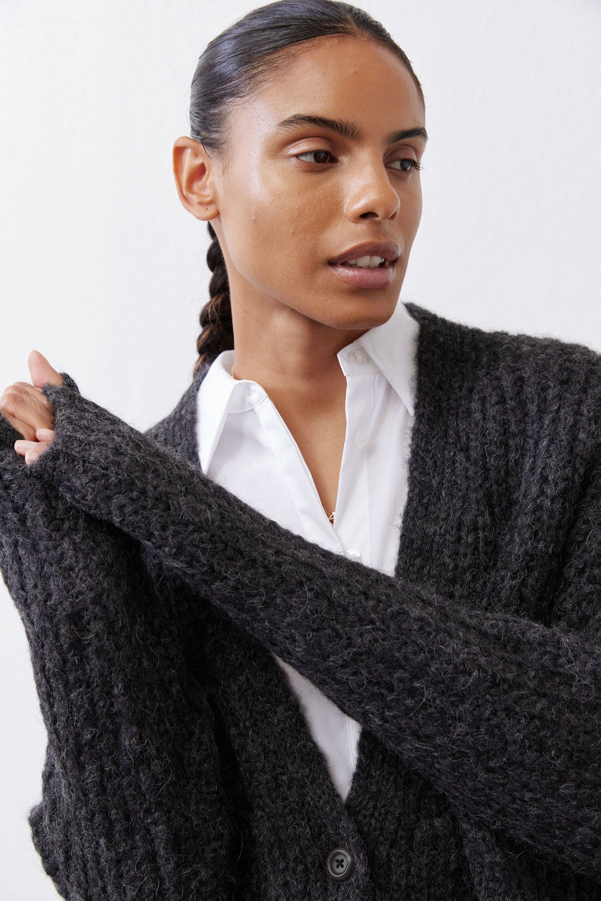 Charcoal heather knit cardigan close-up with textured knit and button front