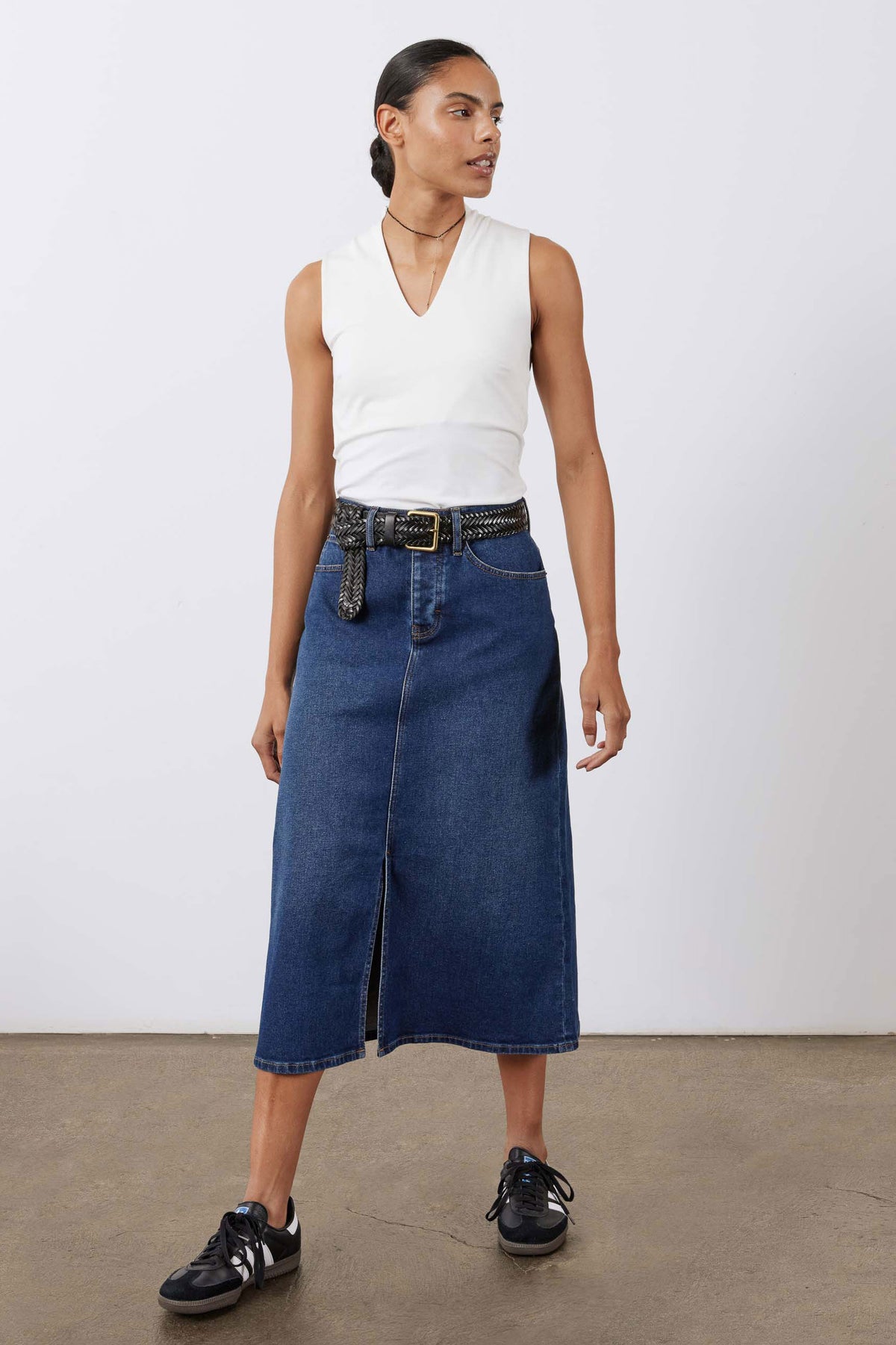 Women’s denim midi skirt in medium wash blue with front slit and belted waist