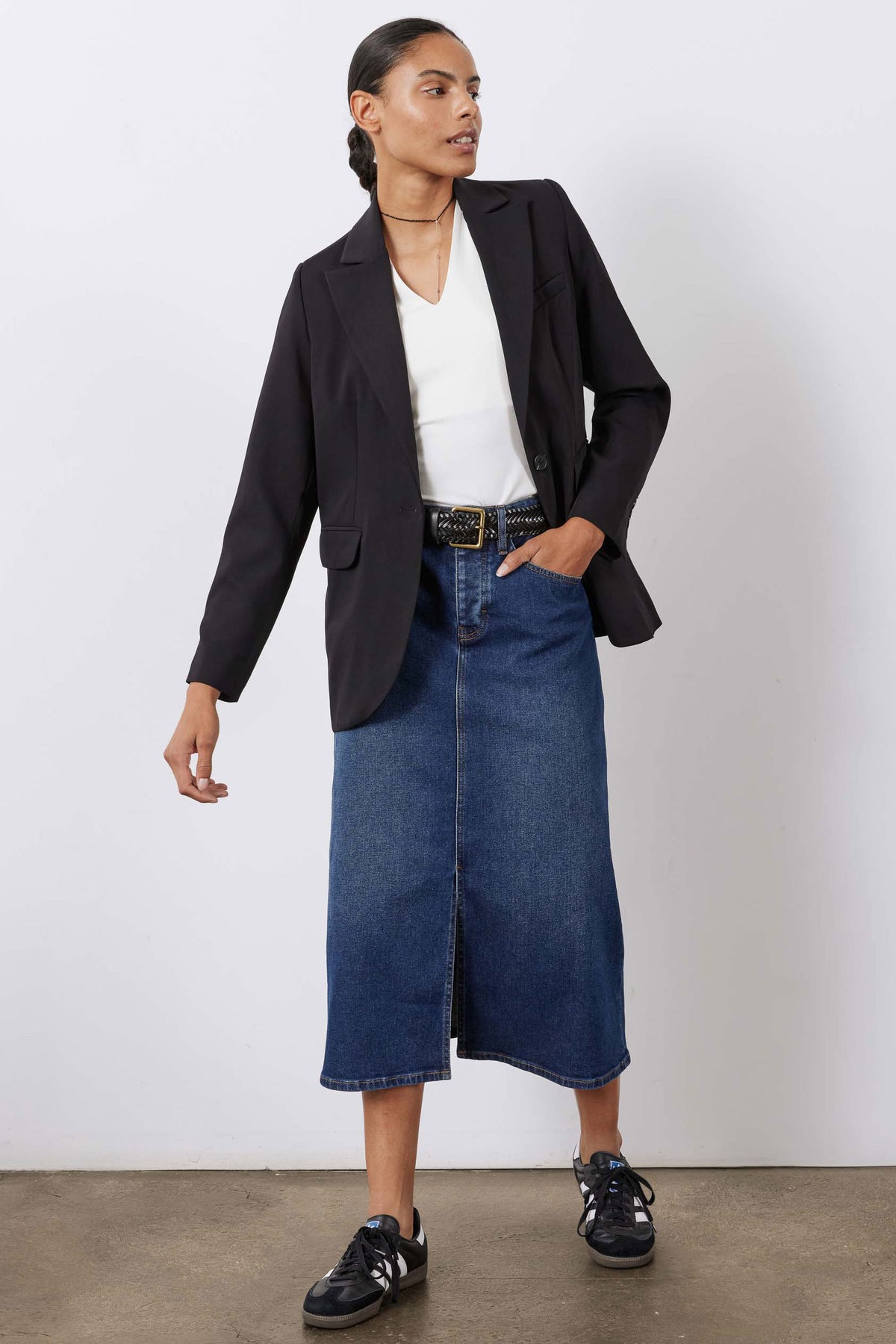 Women’s denim midi skirt in medium wash blue with front slit and center seam