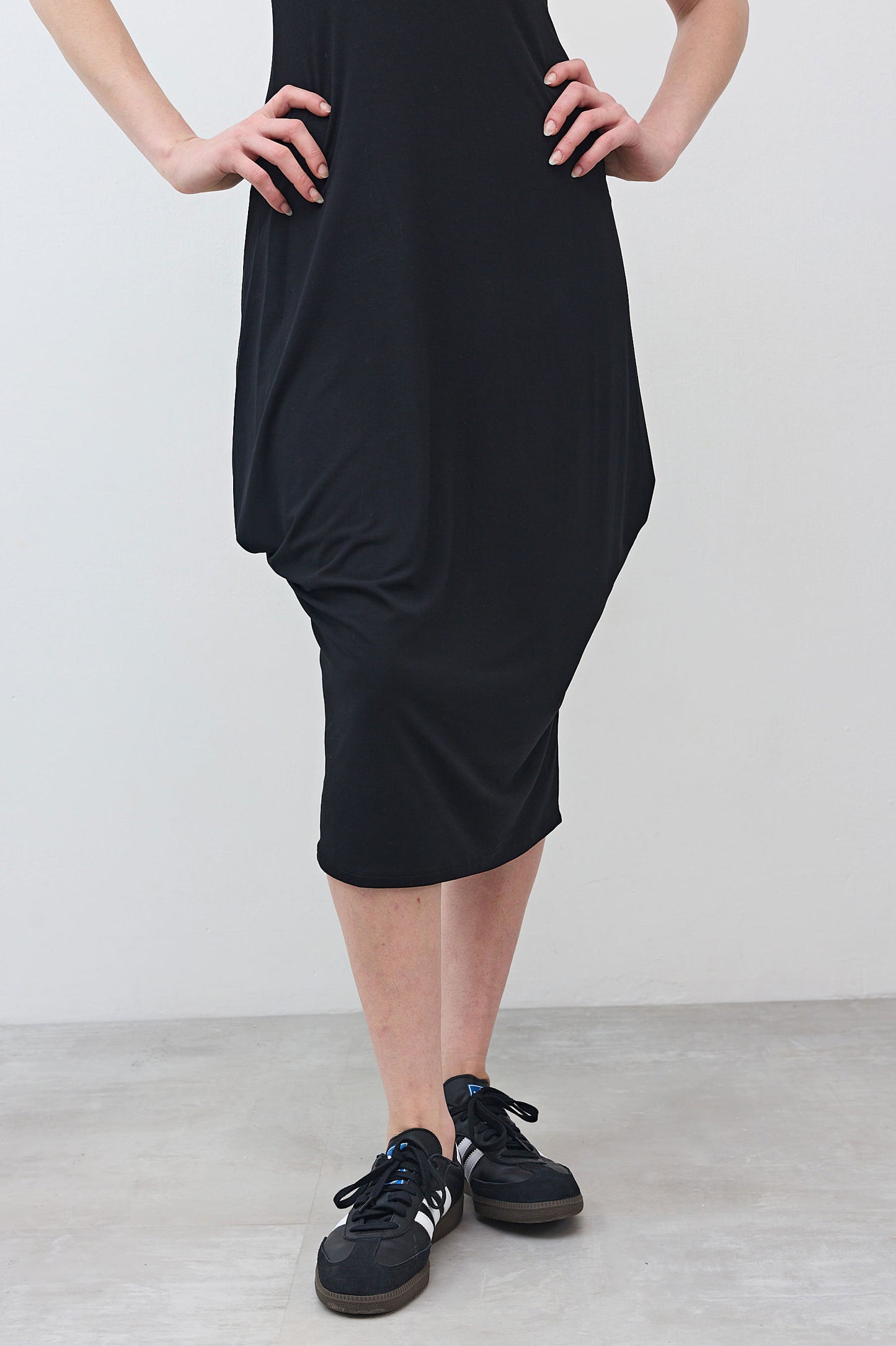 Black short-sleeve jersey dress, midi length, draped skirt detail at side