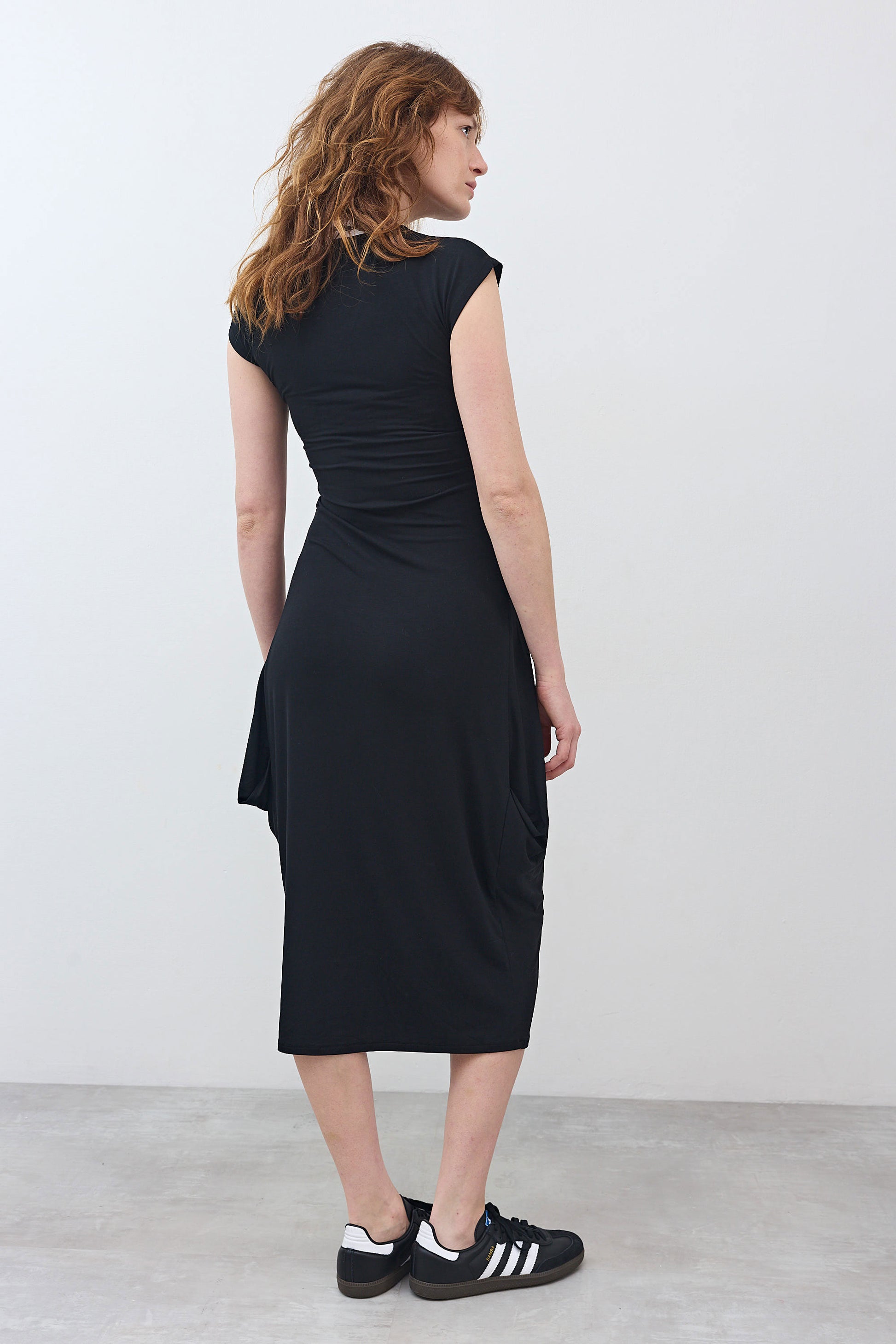 Black short-sleeve jersey dress, back view, side drape detail, midi length
