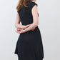 Black short-sleeve jersey dress, side view, fitted through waist, midi length
