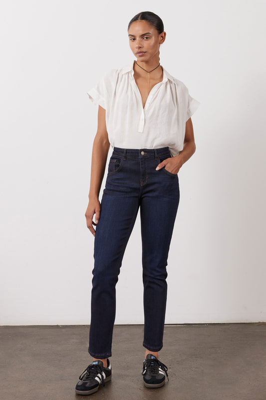 Dark blue fitted jeans with five pockets and belt loops, full front view