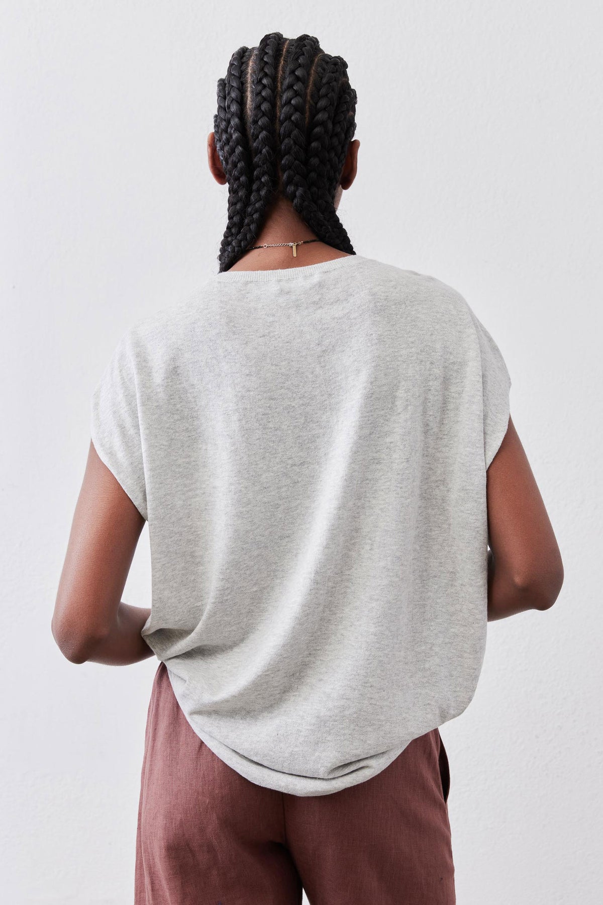 Light sweater top in heather light gray, back view with relaxed short sleeves