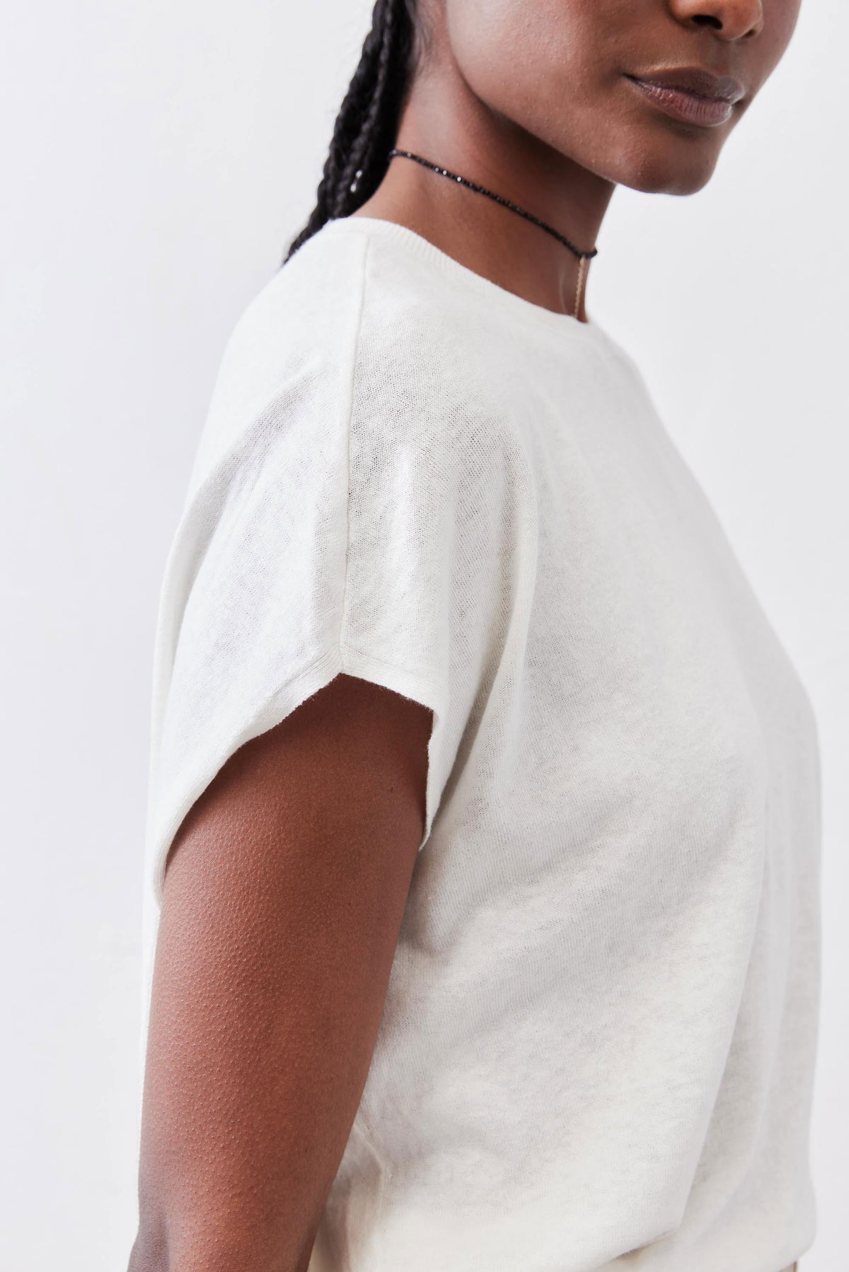 White light sweater top with short sleeves and crew neckline, relaxed fit