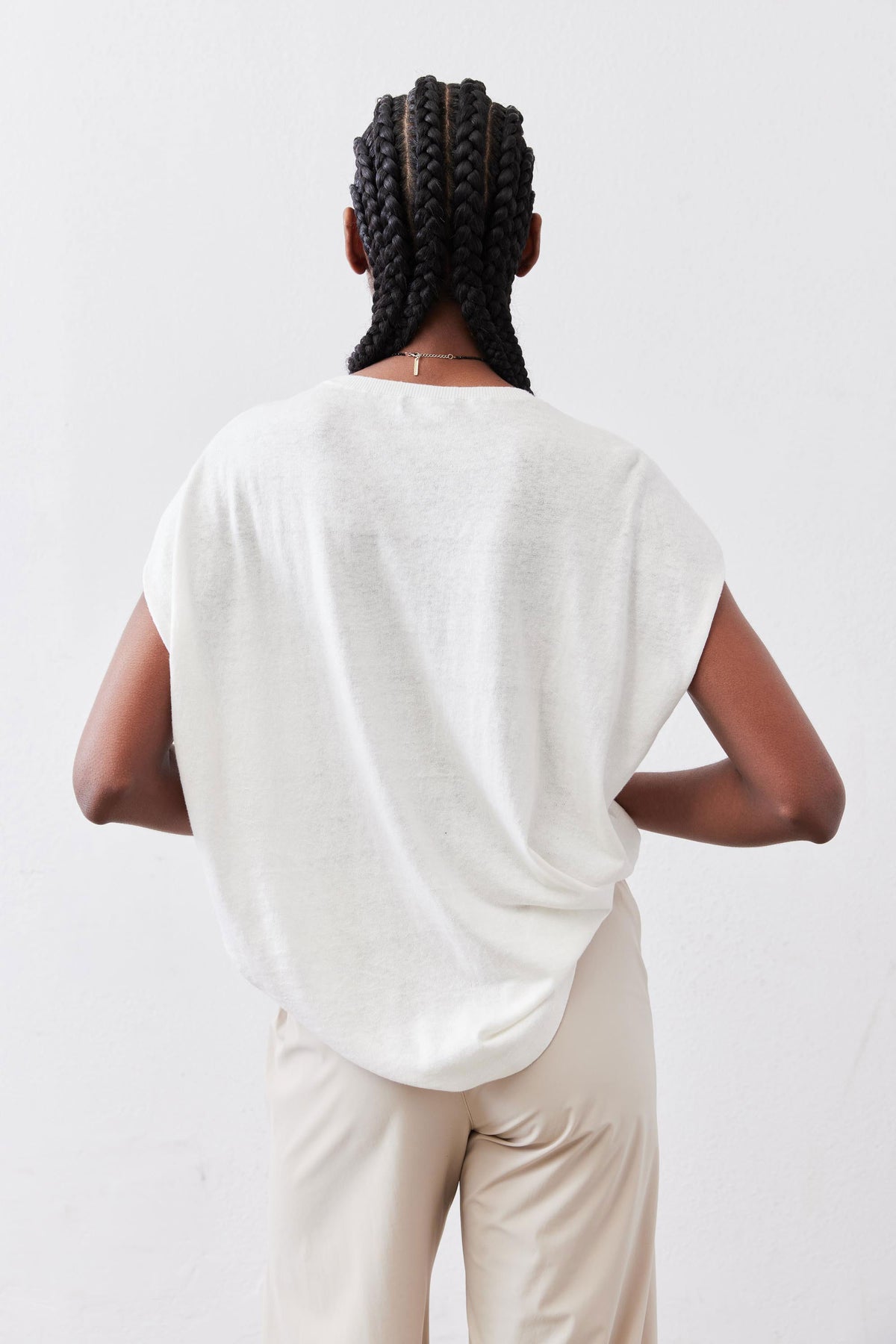 White light sweater top, back view showing crew neckline and short sleeves