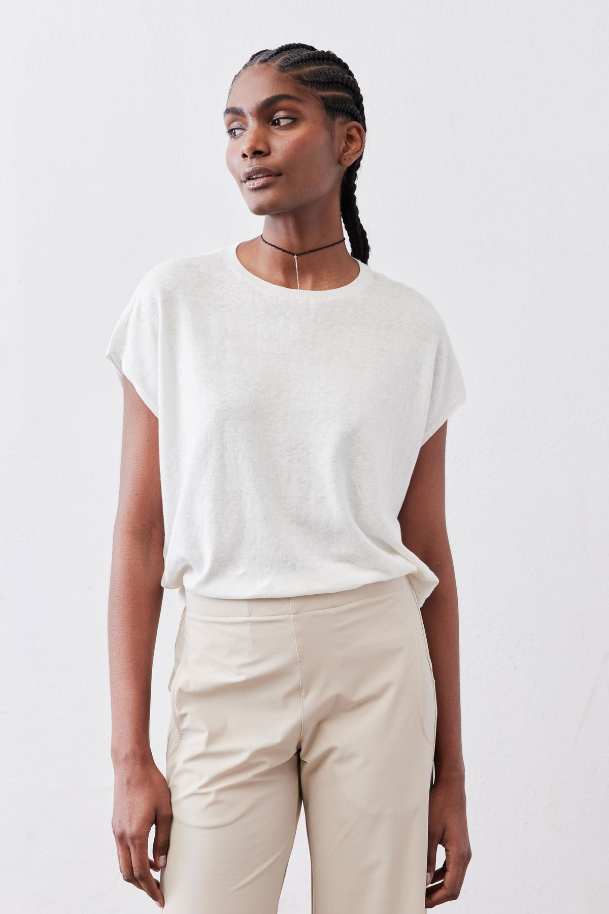 White light sweater top with short sleeves and crew neckline, side view