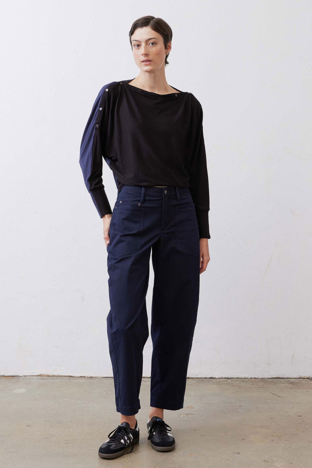 Navy long sleeve top with relaxed fit and snap-button shoulder details