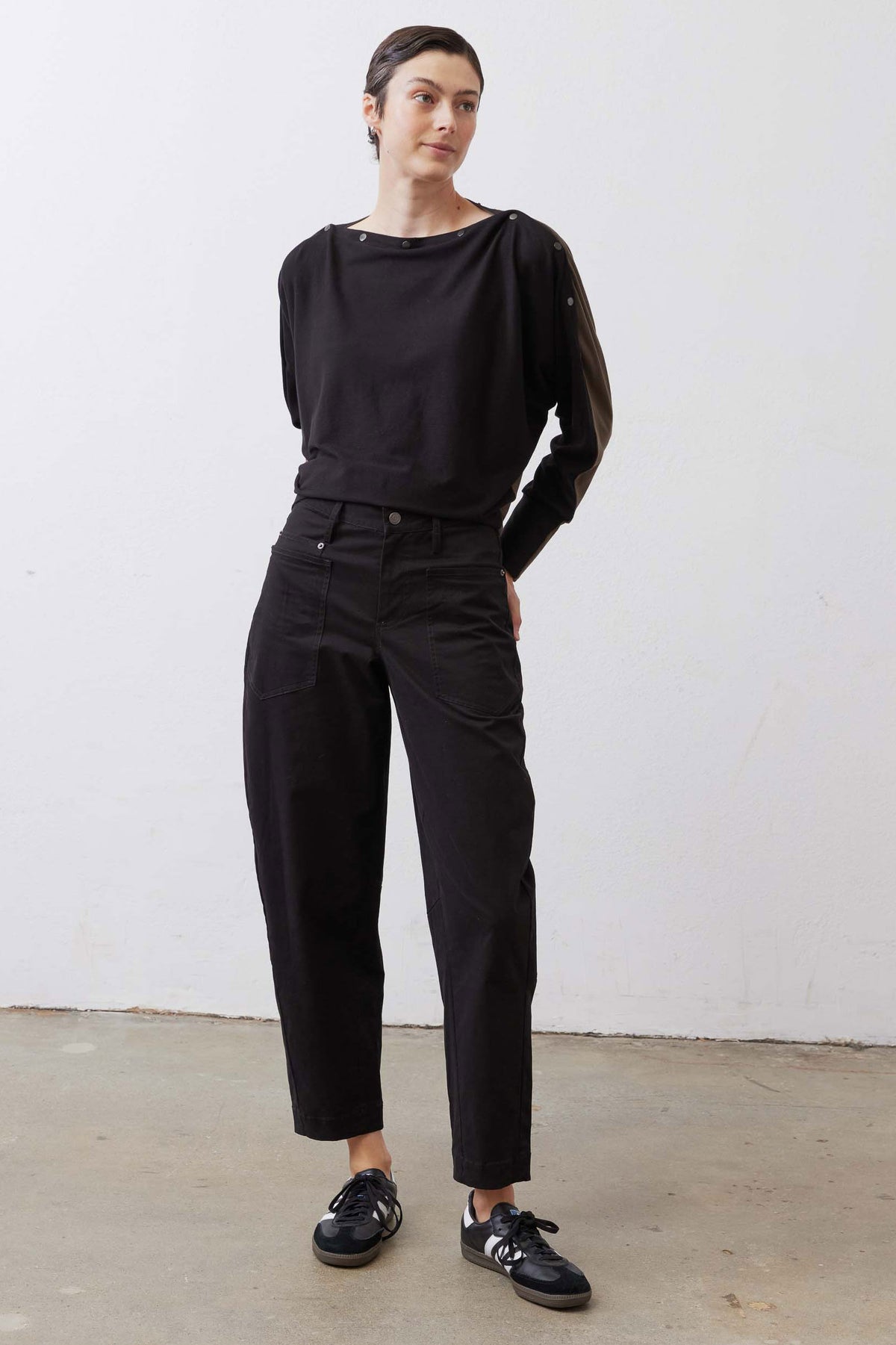 Black long sleeve top with snap buttons on shoulders and neckline