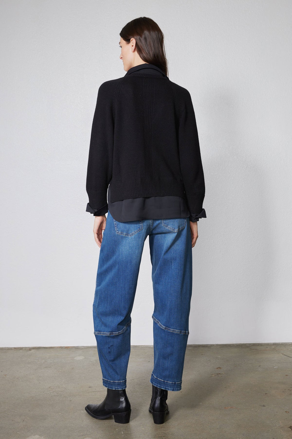 Black pullover sweater shirt, back view with ribbed hem and long sleeves