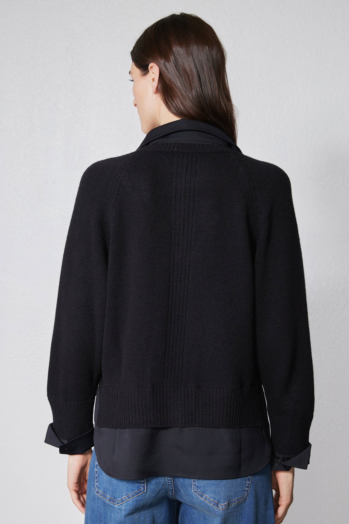 Black knit pullover sweater shirt, back view with ribbed cuffs and hem band