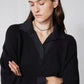 Black pullover sweater shirt with collared V-neck and textured knit sleeves