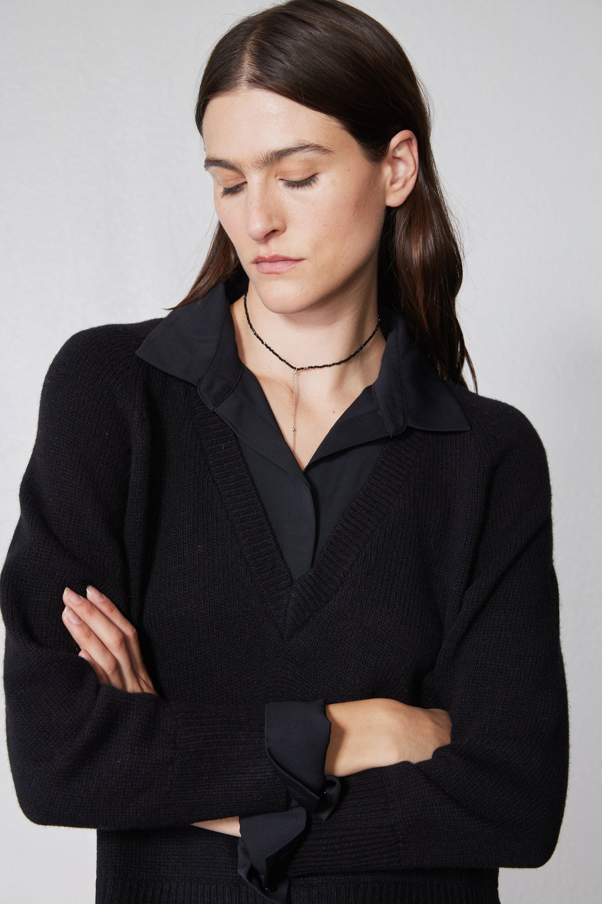 Black pullover sweater shirt with collared V-neck and textured knit sleeves