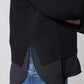 Black knit pullover sweater shirt hem with dark underlayer peeking out