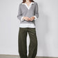Gray pullover sweater with white collared shirt underneath and layered hem and cuffs