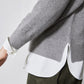Gray pullover sweater with ribbed knit cuffs and hem over a white shirt