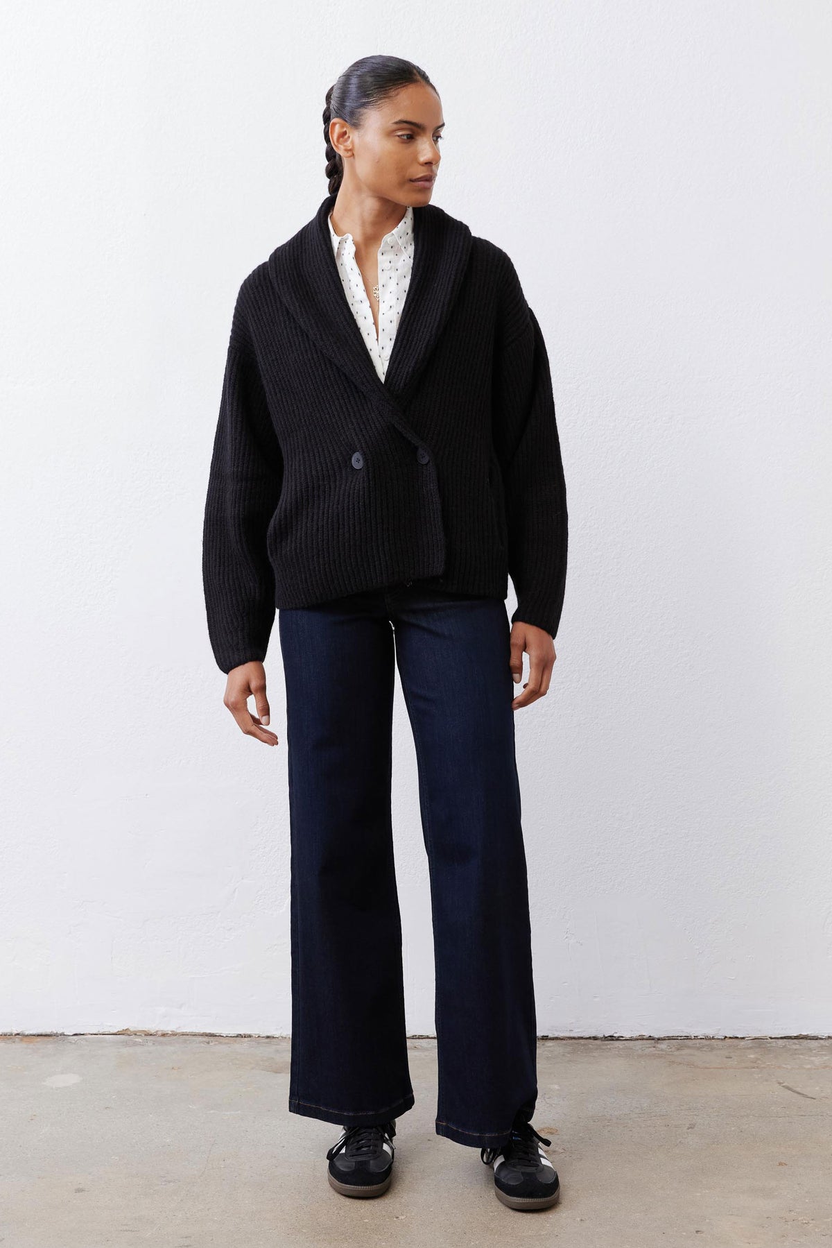 Black knit shawl cardigan with button front, ribbed trim, and long sleeves