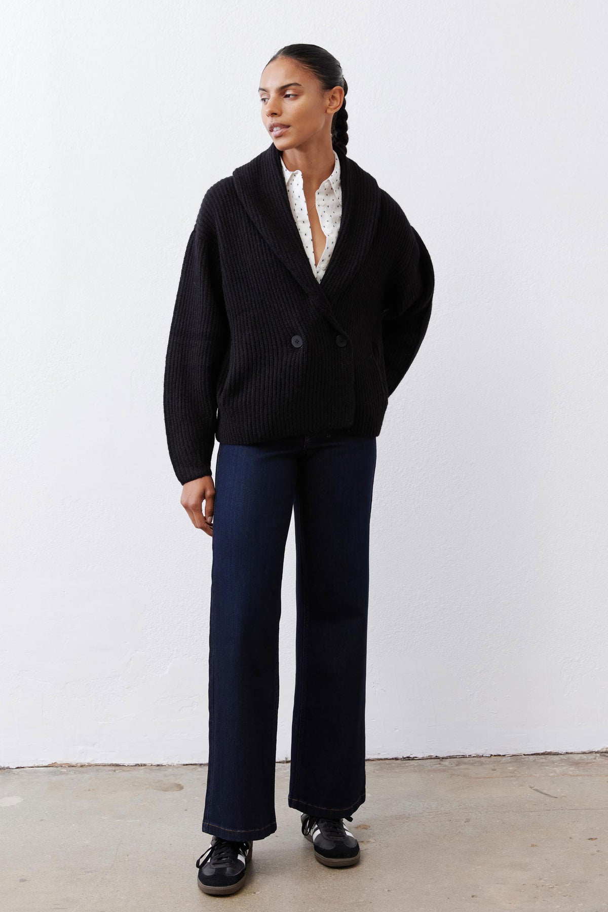 Black knit shawl cardigan with button closure and ribbed collar and hem