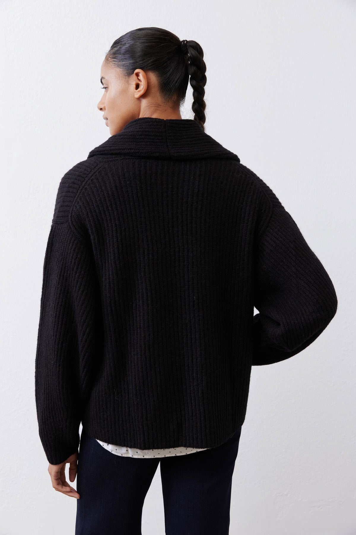 Back view of black rib-knit shawl cardigan with ribbed texture and hem
