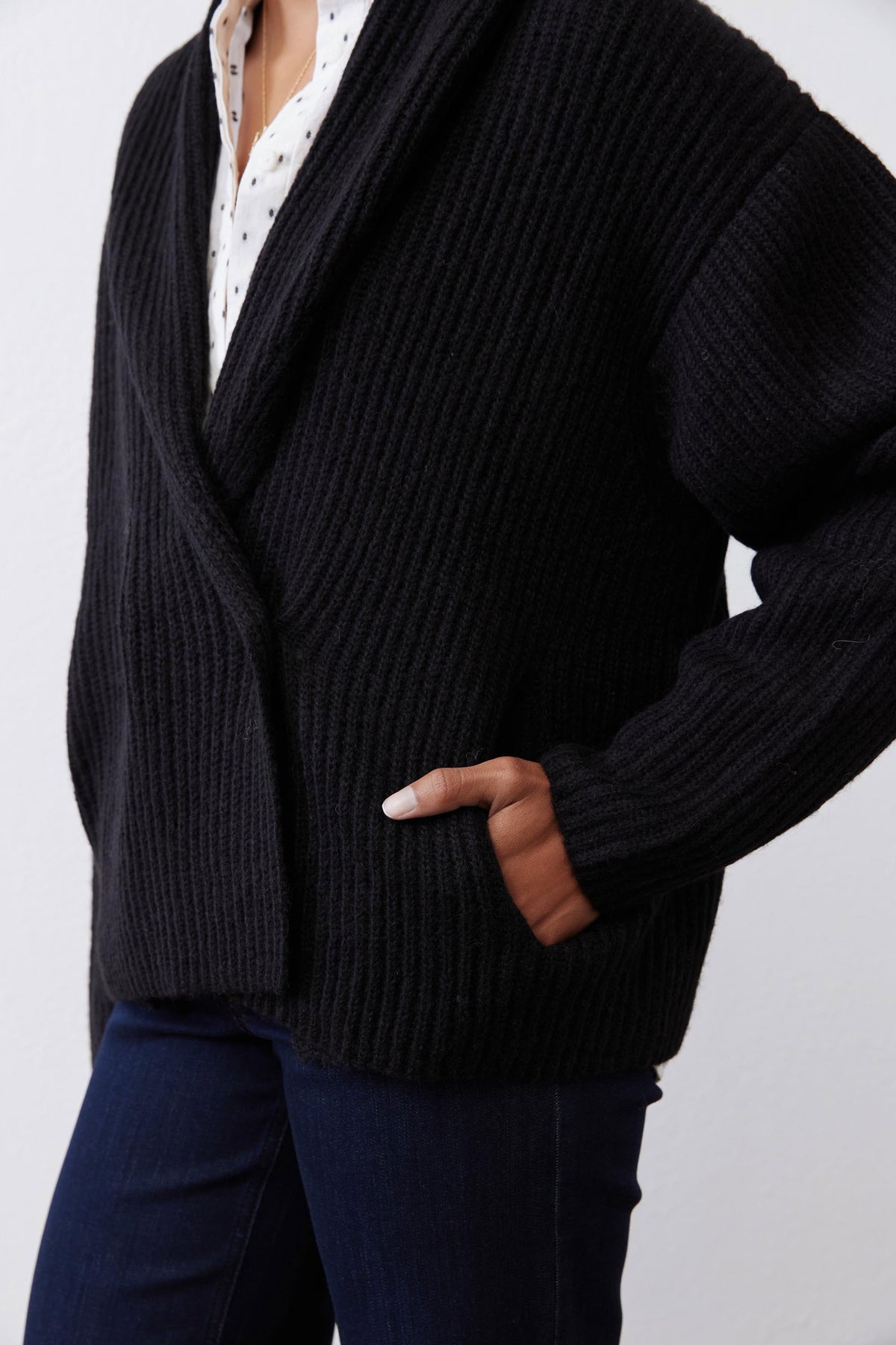 Black knit shawl collar cardigan with button front and ribbed cuffs