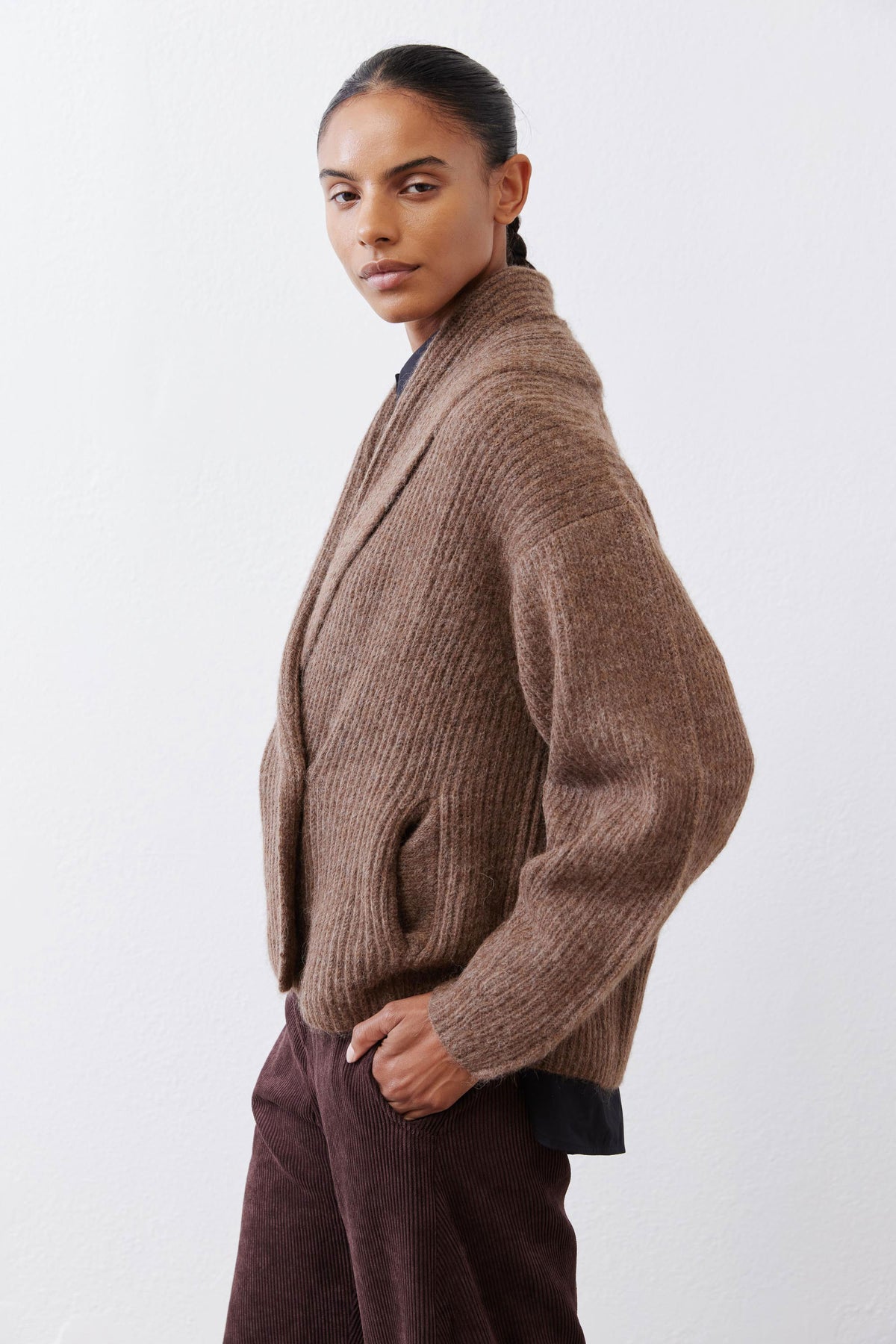 Oatmeal knit shawl-collar cardigan, side view with ribbed texture and sleeves