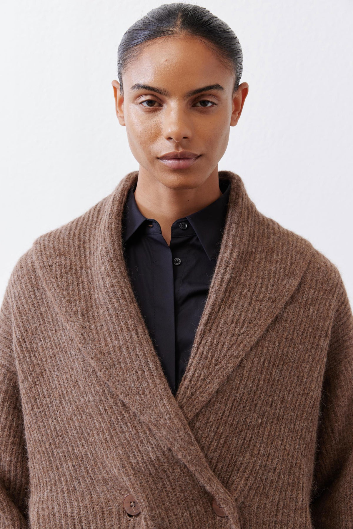 Oatmeal shawl-collar knit cardigan close-up with buttons and textured knit weave