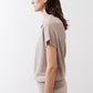 Misty gray short-sleeve sweater from side view with draped cowl neckline