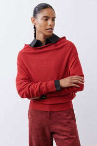 Red knit sweater with black collared neck and ribbed cuffs.