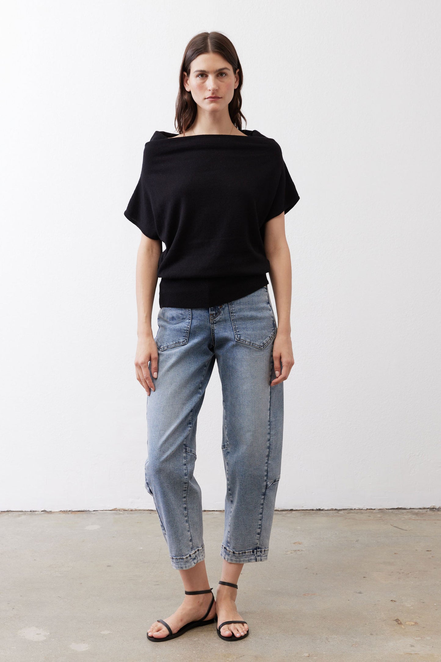 Black short-sleeve sweater with relaxed fit and draped neckline