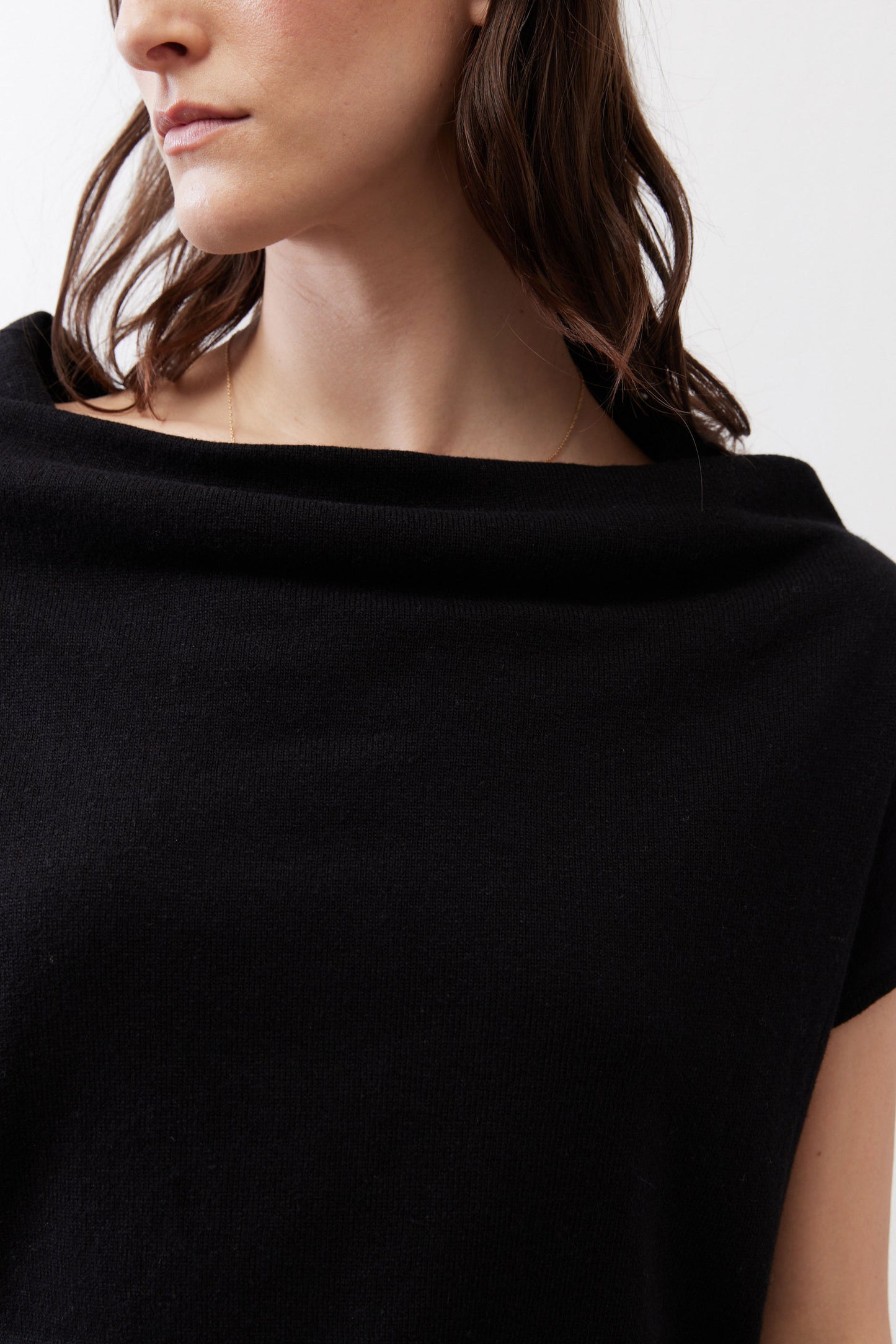 Black knit sweater neckline close-up with soft drape