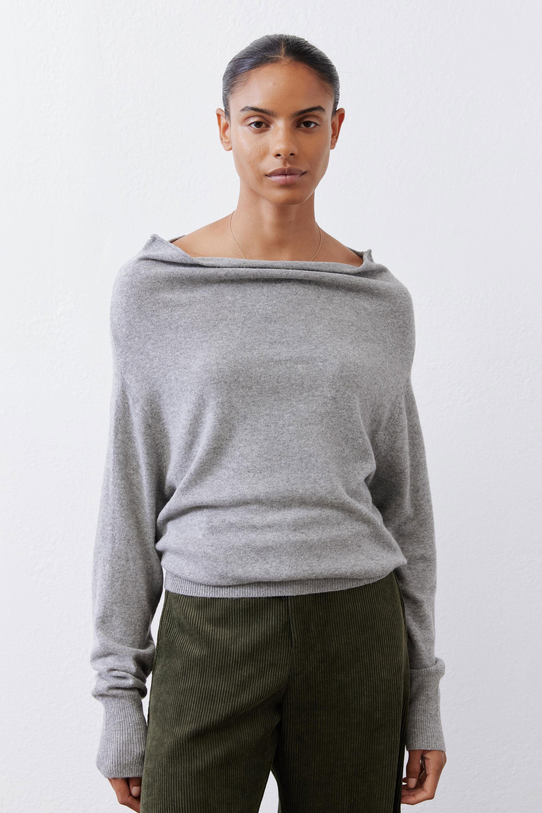 Silver heather knit crewneck sweater with long sleeves and dropped shoulders.