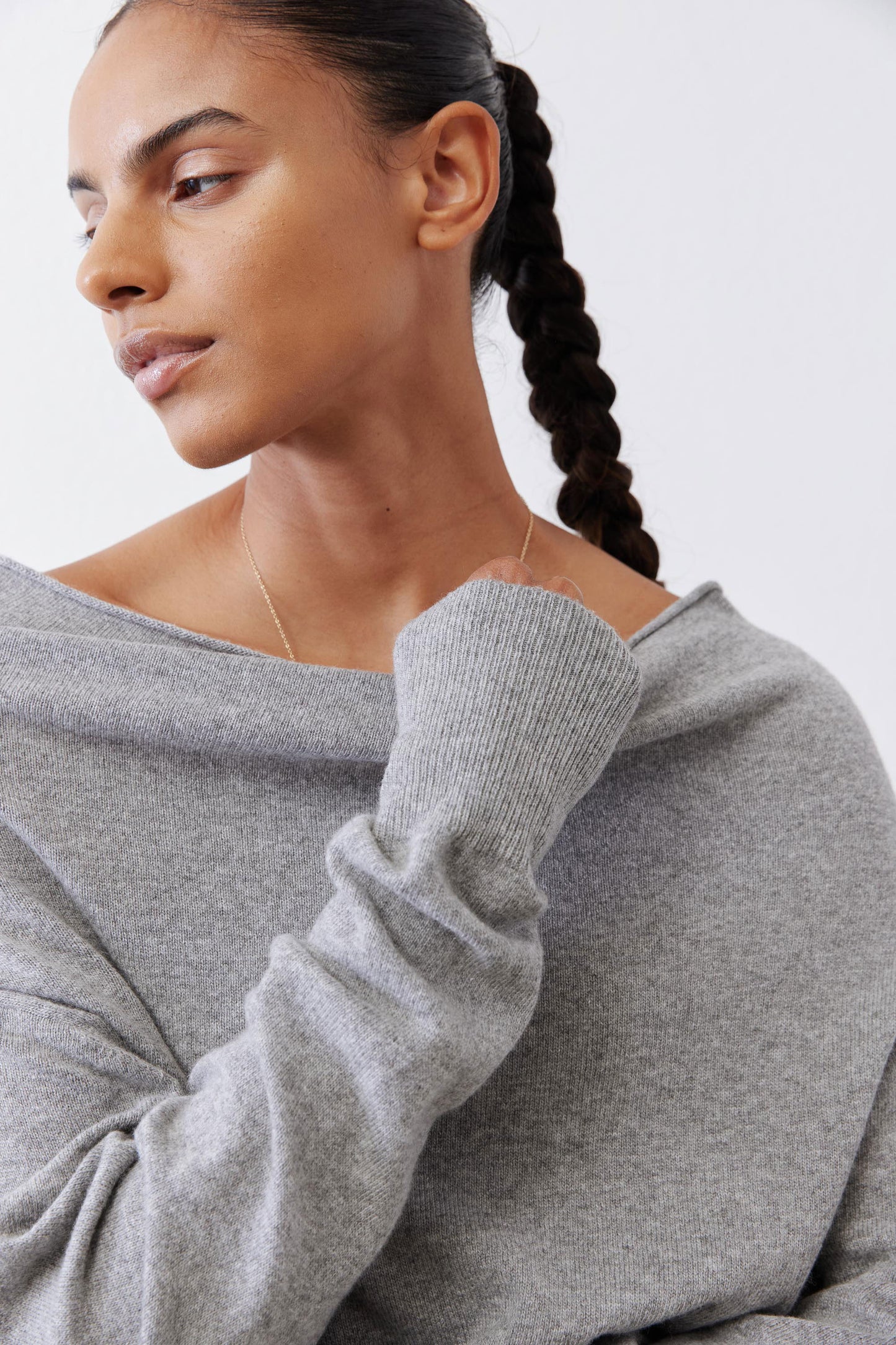 Silver heather knit sweater close-up, crew neckline and ribbed sleeve cuffs.