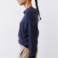 Navy cowl-neck sweater side profile with long sleeves and relaxed hem