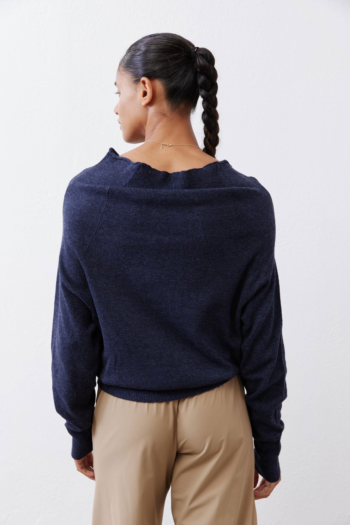 Navy cowl-neck sweater back view with long sleeves and banded hem