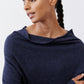 Navy cowl-neck sweater close-up with soft knit and ribbed cuff