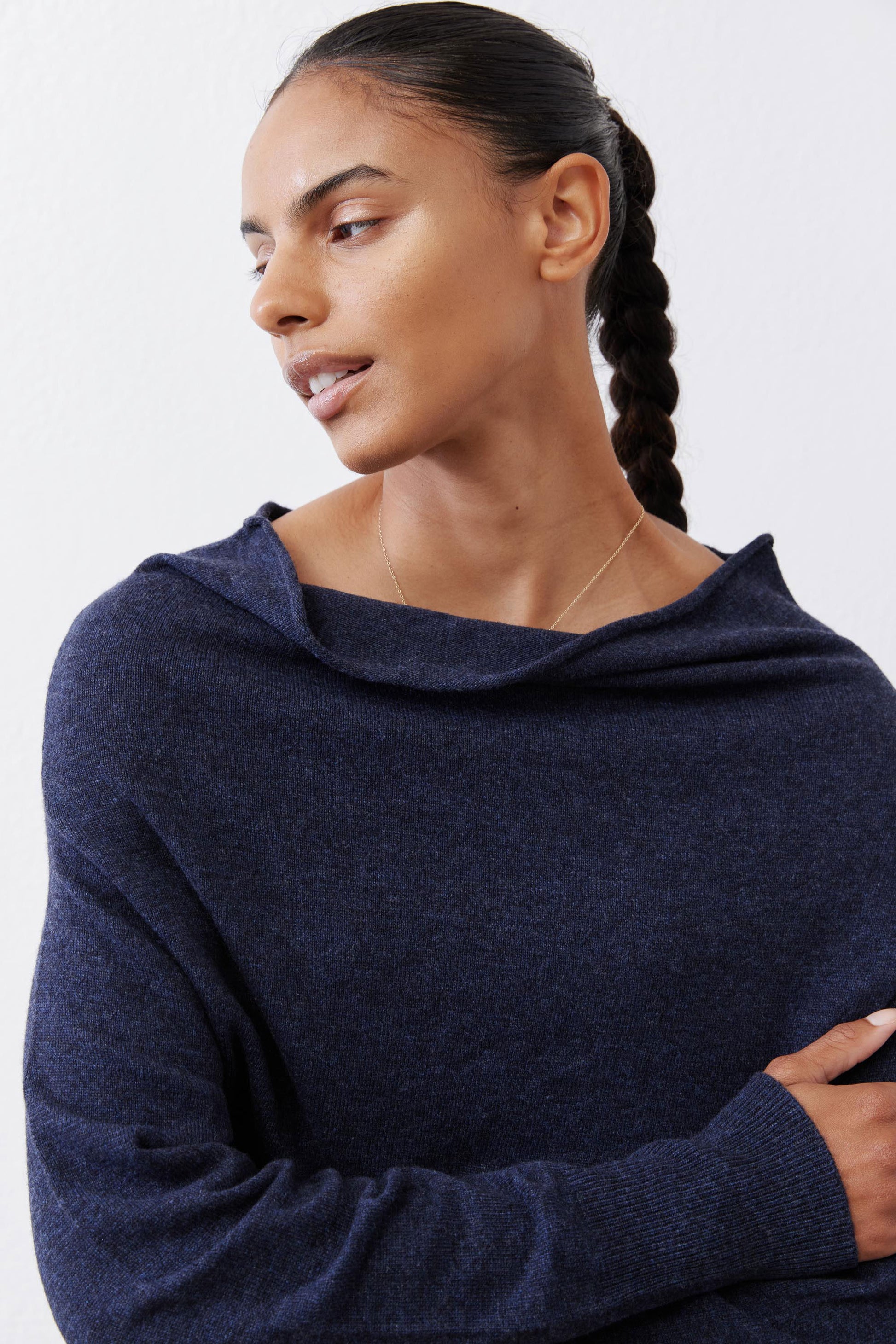Navy cowl-neck sweater close-up with soft knit and ribbed cuff