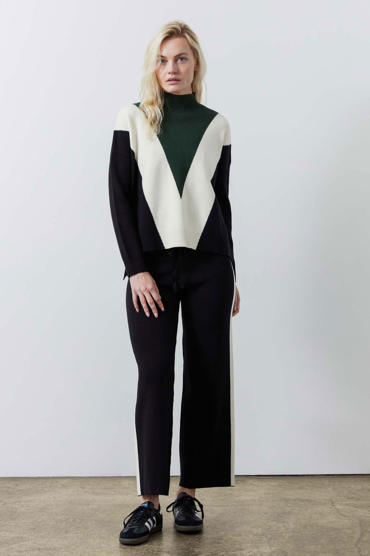 Chevron colorblock knit sweater in dark green, cream, and black; long sleeves