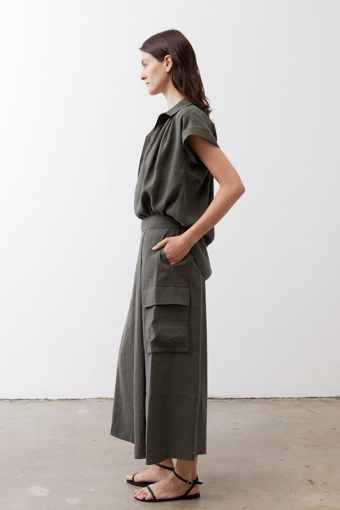 Olive cargo skirt pants with hip cargo pocket and relaxed wide-leg drape