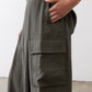 Olive cargo skirt pants with large front patch pockets and flap details