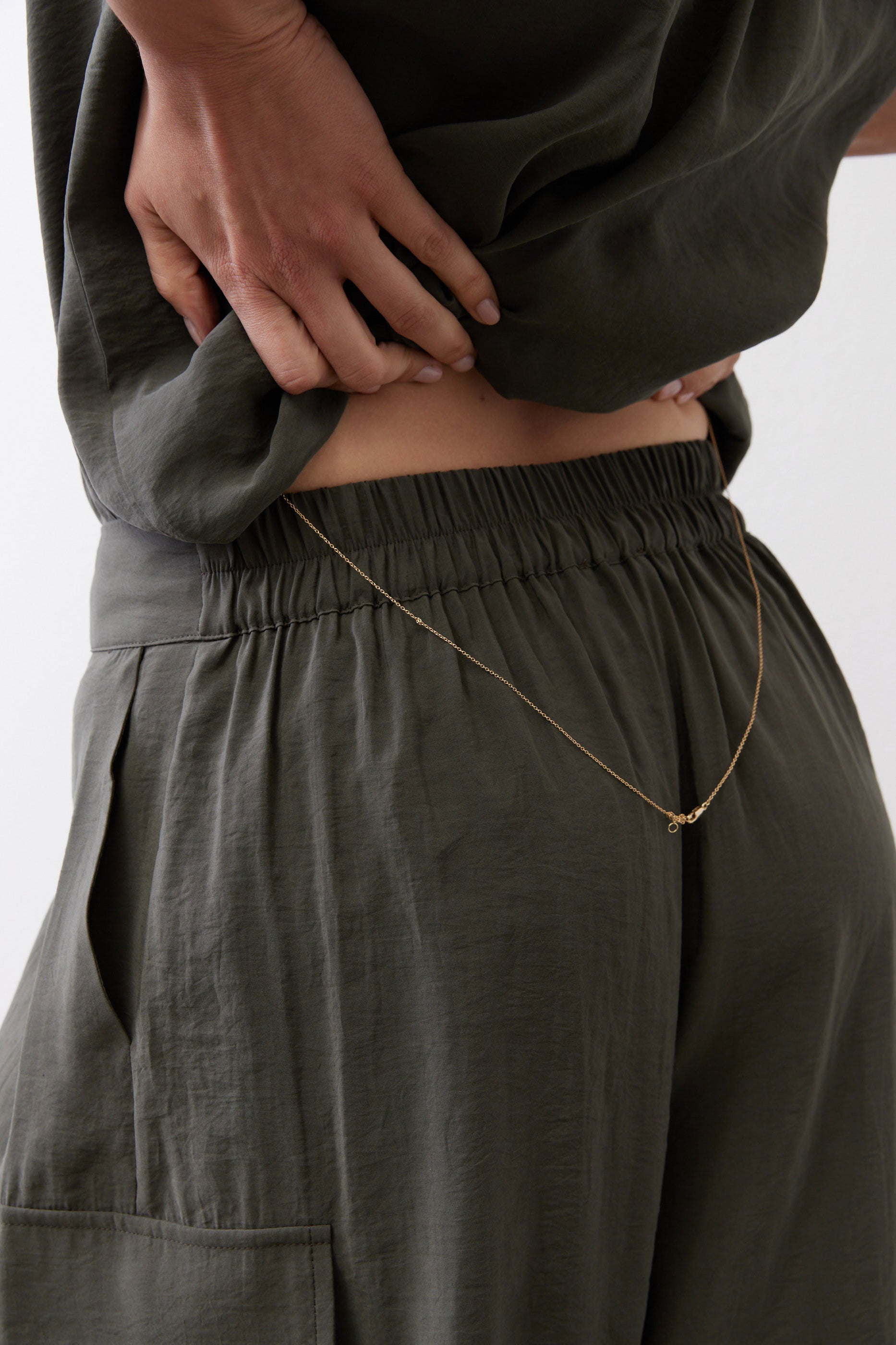 Olive cargo skirt pants with elastic waistband and front pocket detail