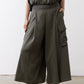Olive cargo skirt pants with side cargo pockets and wide, draped legs