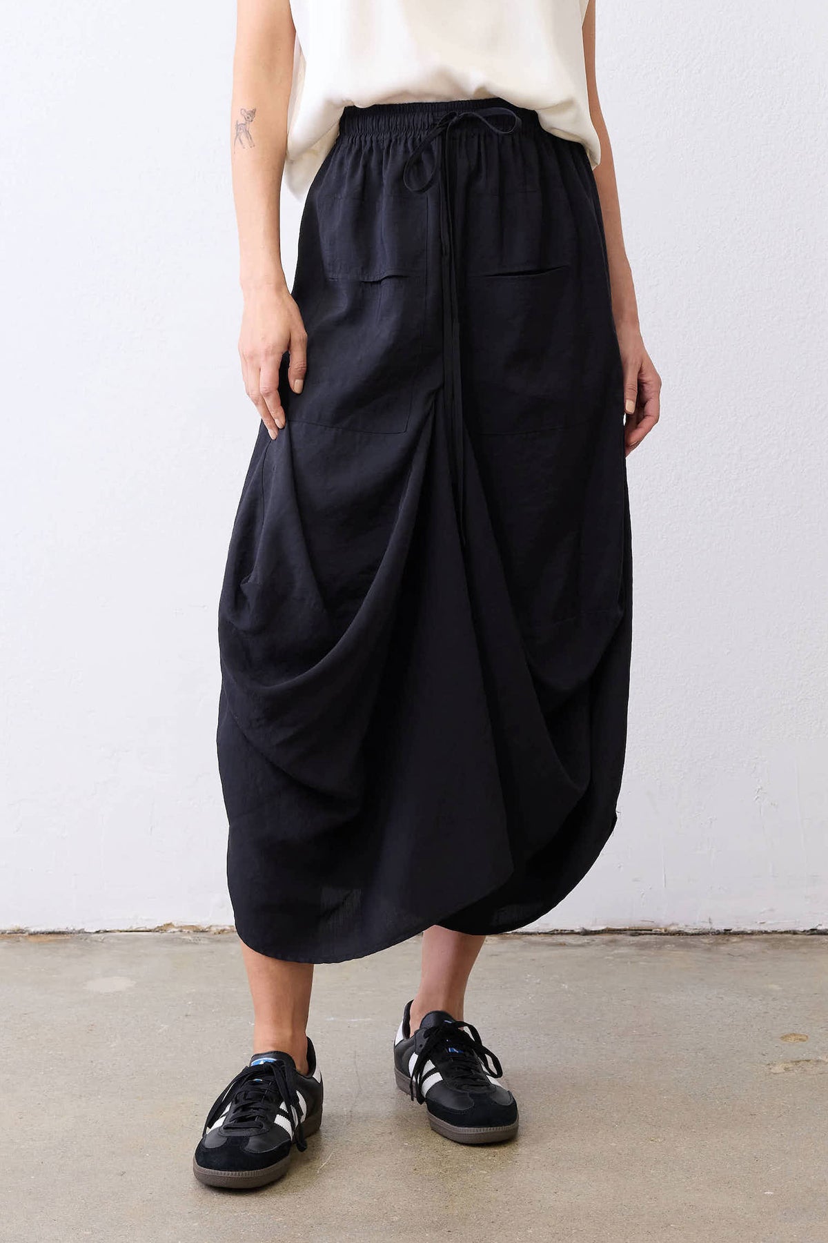 Black drawstring-waist draped midi skirt with gathered folds