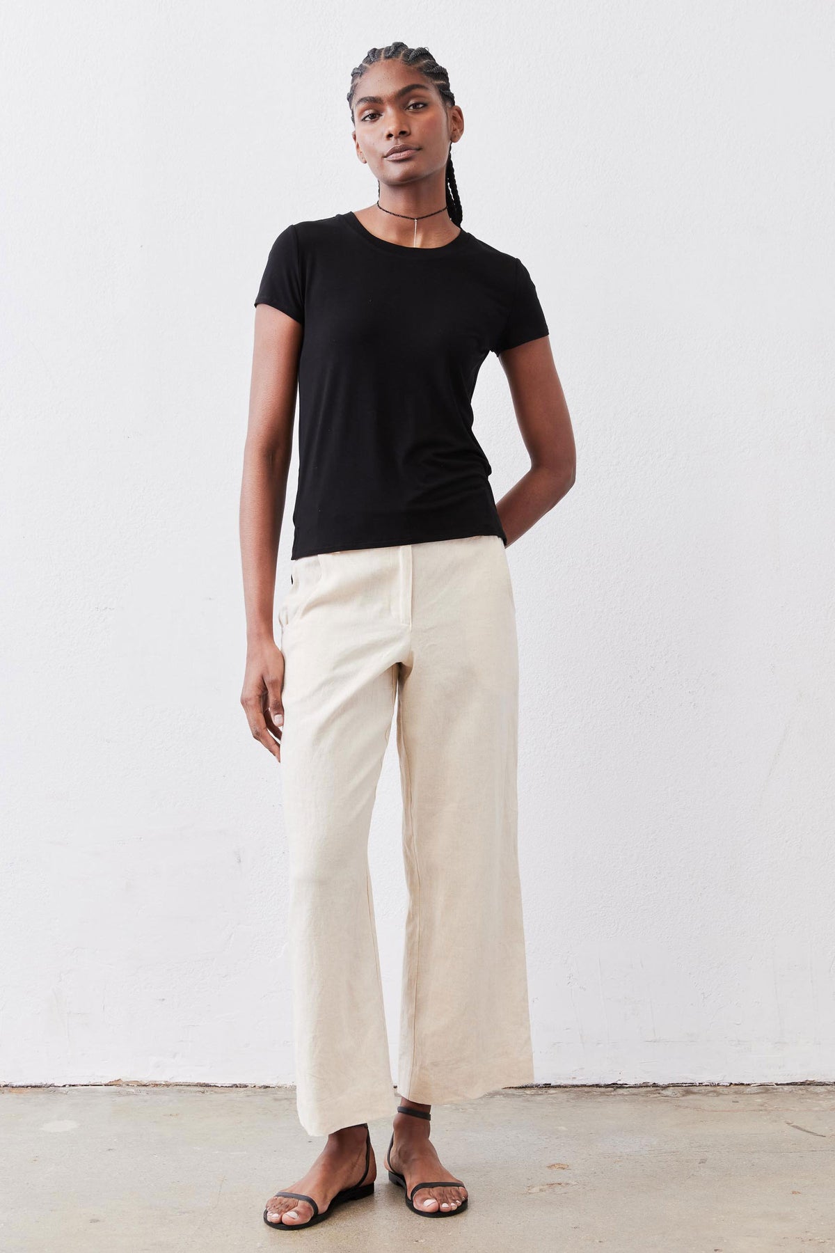 Oat linen A-line pants with wide legs and side pockets, worn with a high waist.