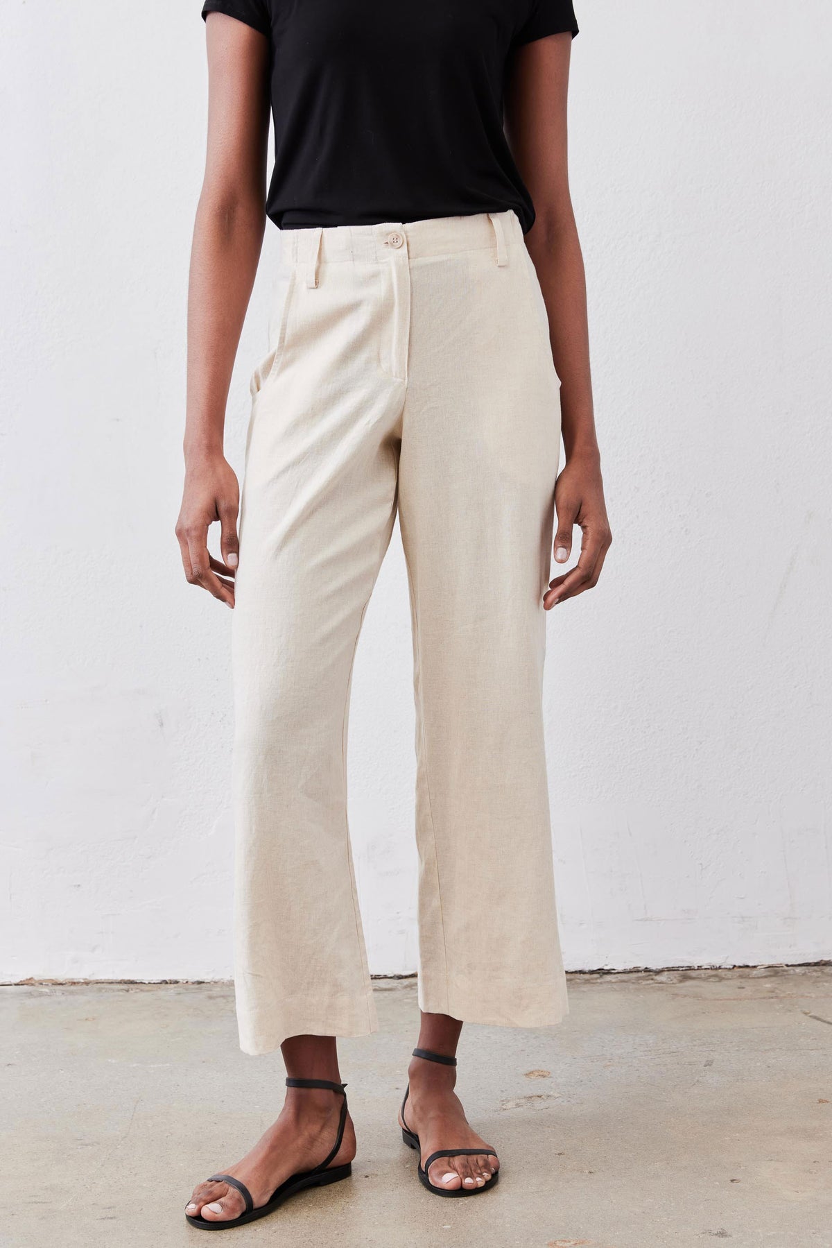 Oat linen A-line pants with wide straight legs and a fitted high waistband.