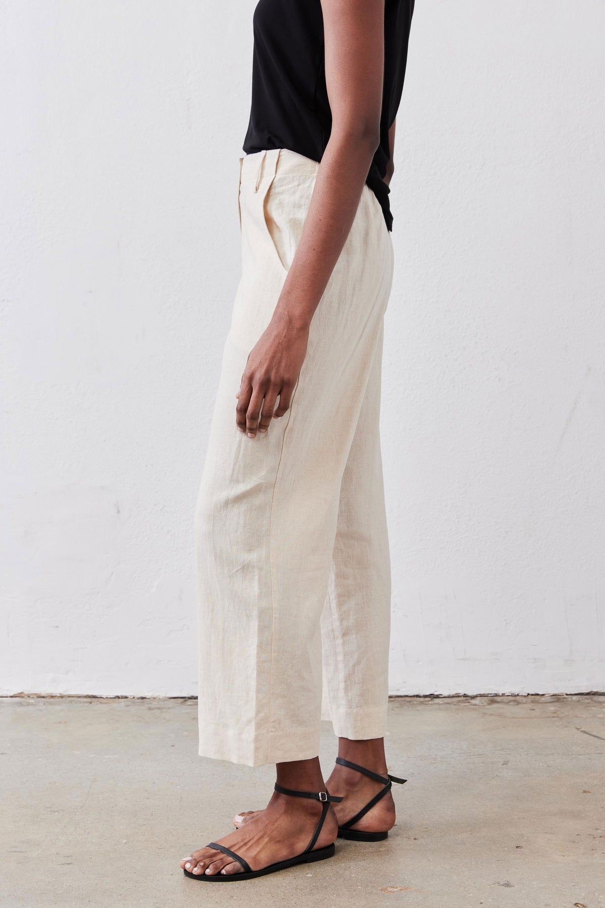 Oat linen A-line pants with wide tapered legs and ankle-length hem.
