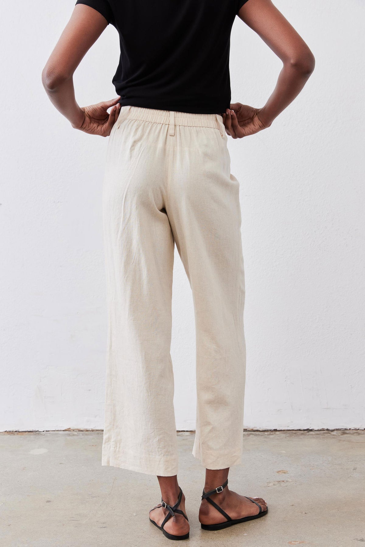 Oat linen A-line pants with elastic waistband and relaxed wide-leg silhouette.